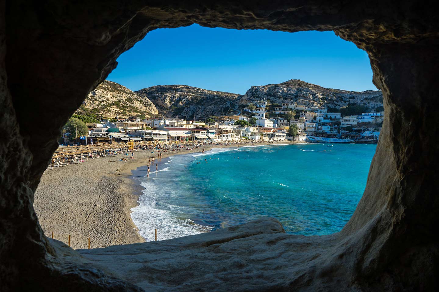 Image of Matala beach Crete from one of the caves on the cliff above