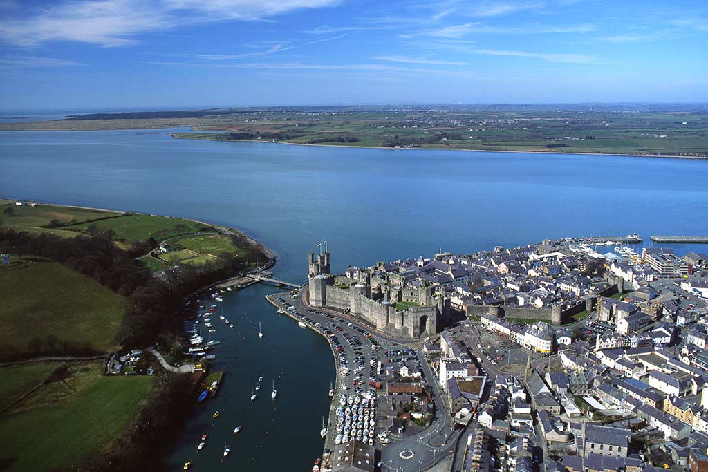 image of aerial view of Caernarfon town and castle gwynedd north Wales uk