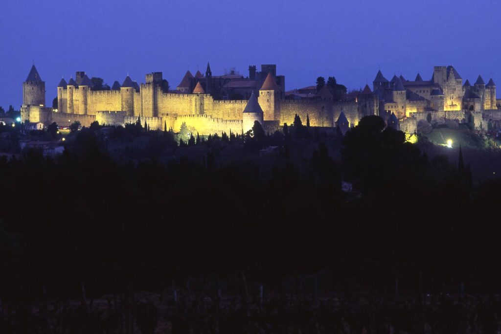 south of france road trip image of carcassonne at dusk