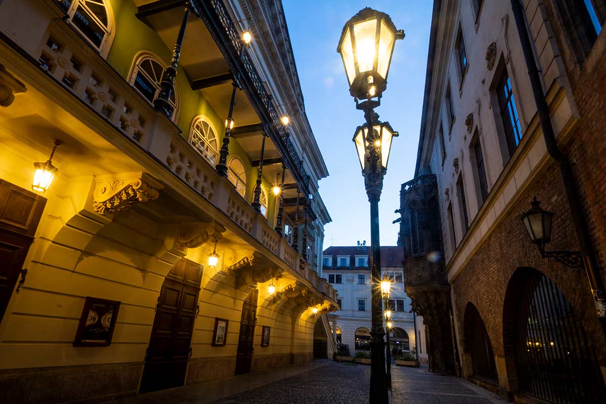 image of ovocny trh street and estates theatre at dusk prague czech republic