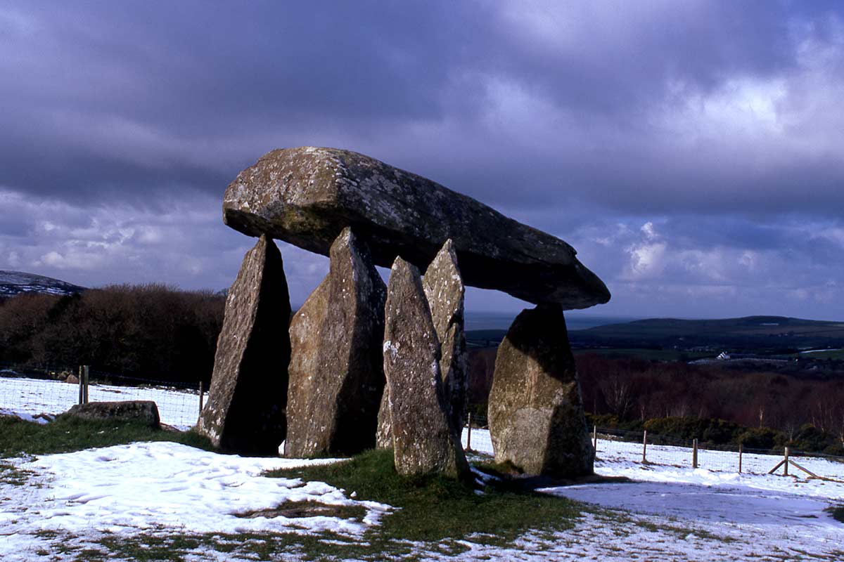 image of pentre ifan burial chamber in snow pembrokeshire wales uk