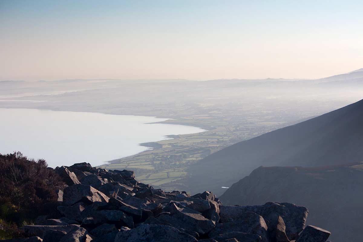 image of tre'r ceiri ironage hillfort looking north up caernarfon bay north wales uk