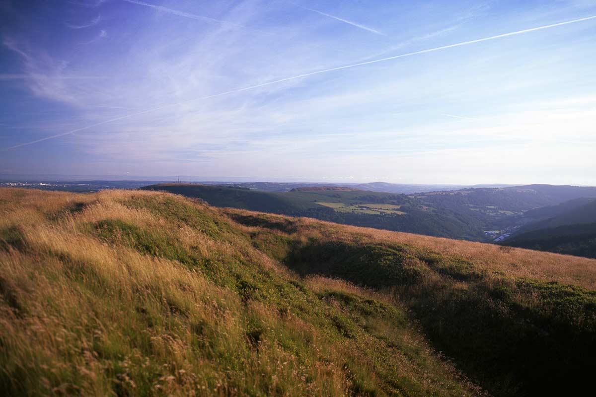 image of iron age earthwork at twmbarlwm hillfort near risca south wales uk