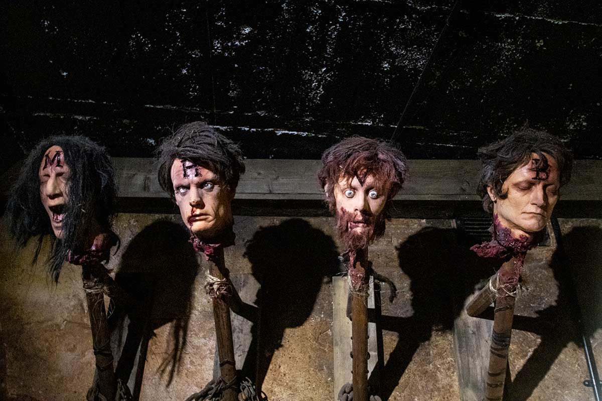 image of heads on spikes at the clink prison museum London England uk