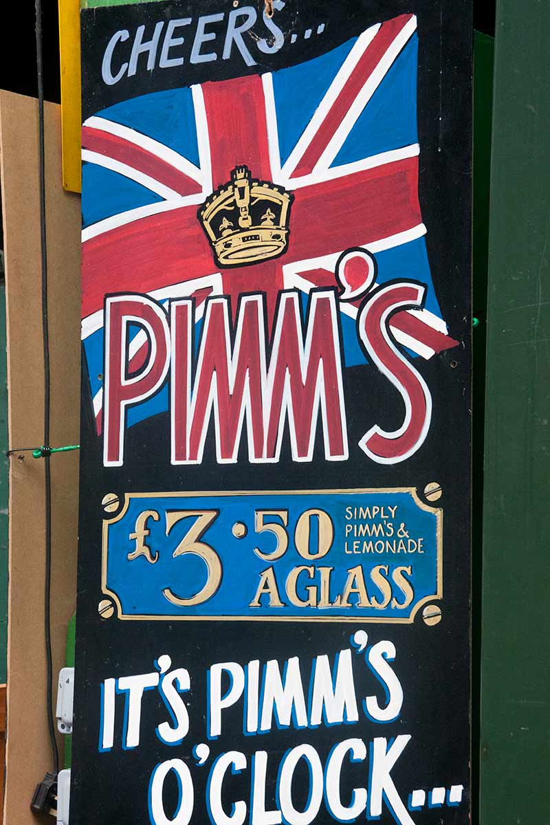 image of blackboard advertising Pimm's at bar in borough market London England uk
