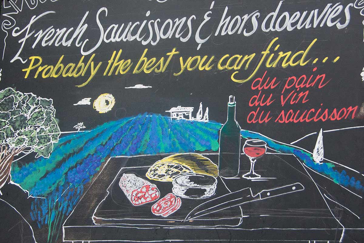 image of board advertising French food stall borough market southwark London England uk