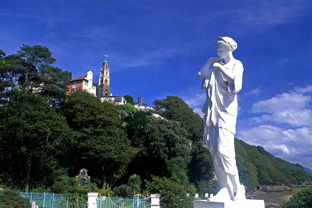 image of statue on riverfront at Portmeirion village gwynedd north Wales uk