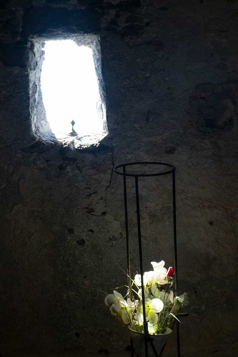 image of light shining on flowers in agios pavlos church Agia Roumeli Crete greece