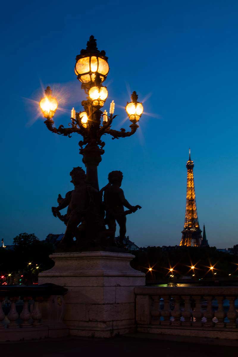 image of pont Alexandre iii and Eiffel Tower at dusk Paris france