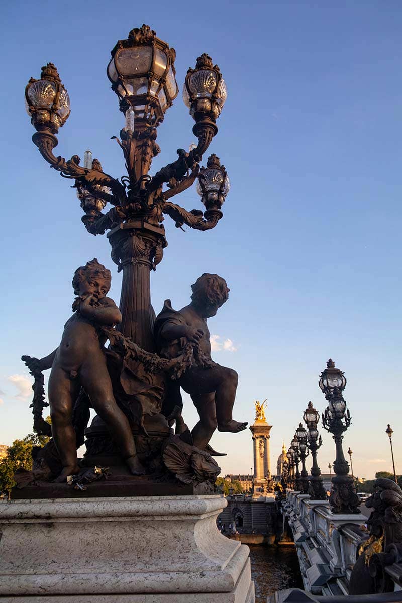 image of statues and lamps on the pont Alexandre iii Paris france