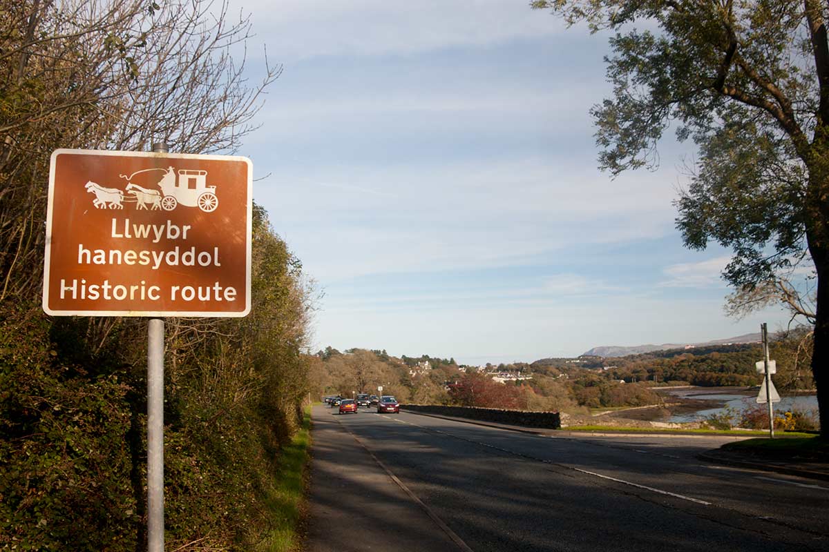 image of historic a5 road sign on anglesey north Wales uk
