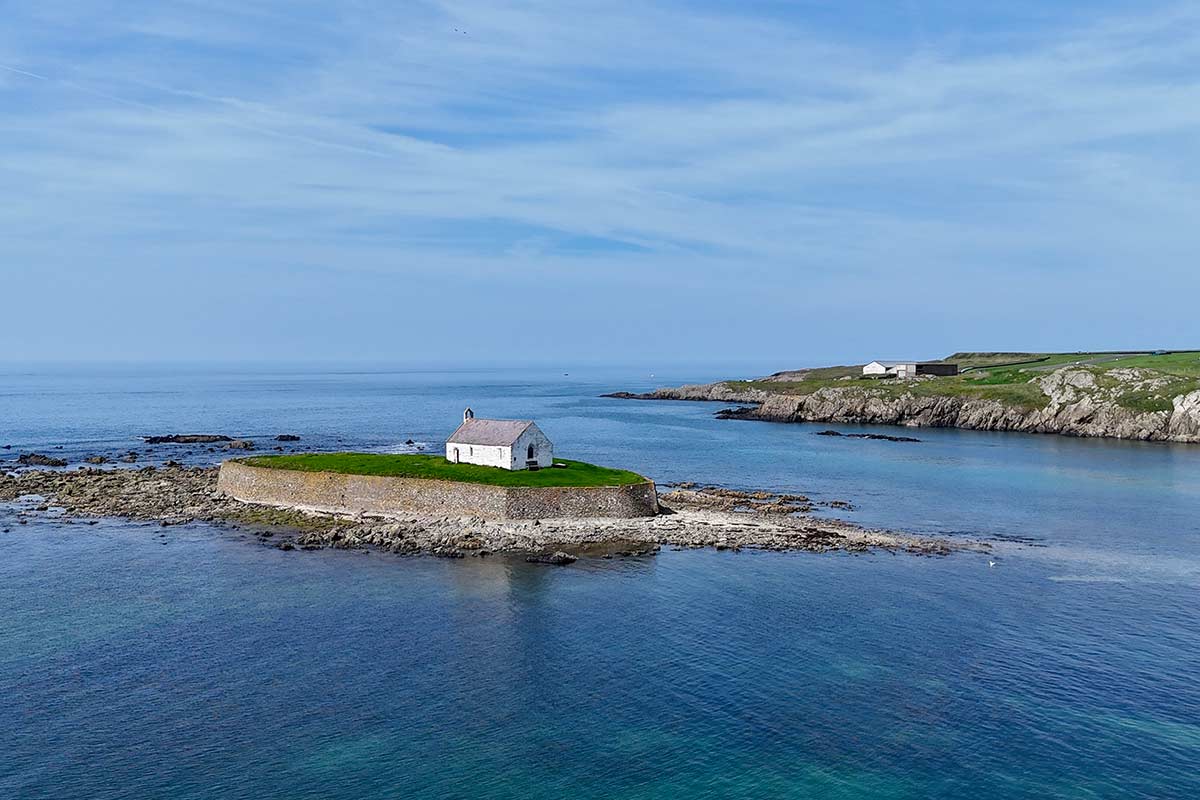 image of aerial view of st Cwyfan's church on island near Aberffraw anglesey north Wales uk