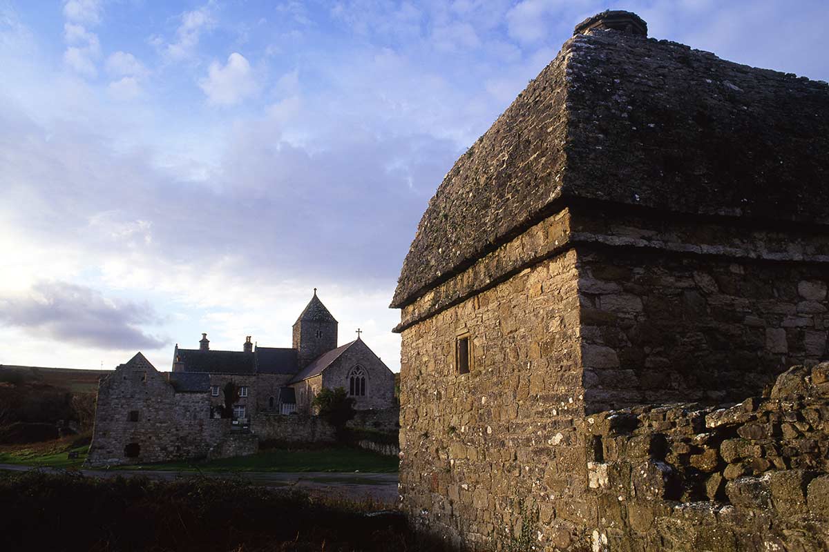 image of pennon dovecote with priory church in background anglesey north Wales uk