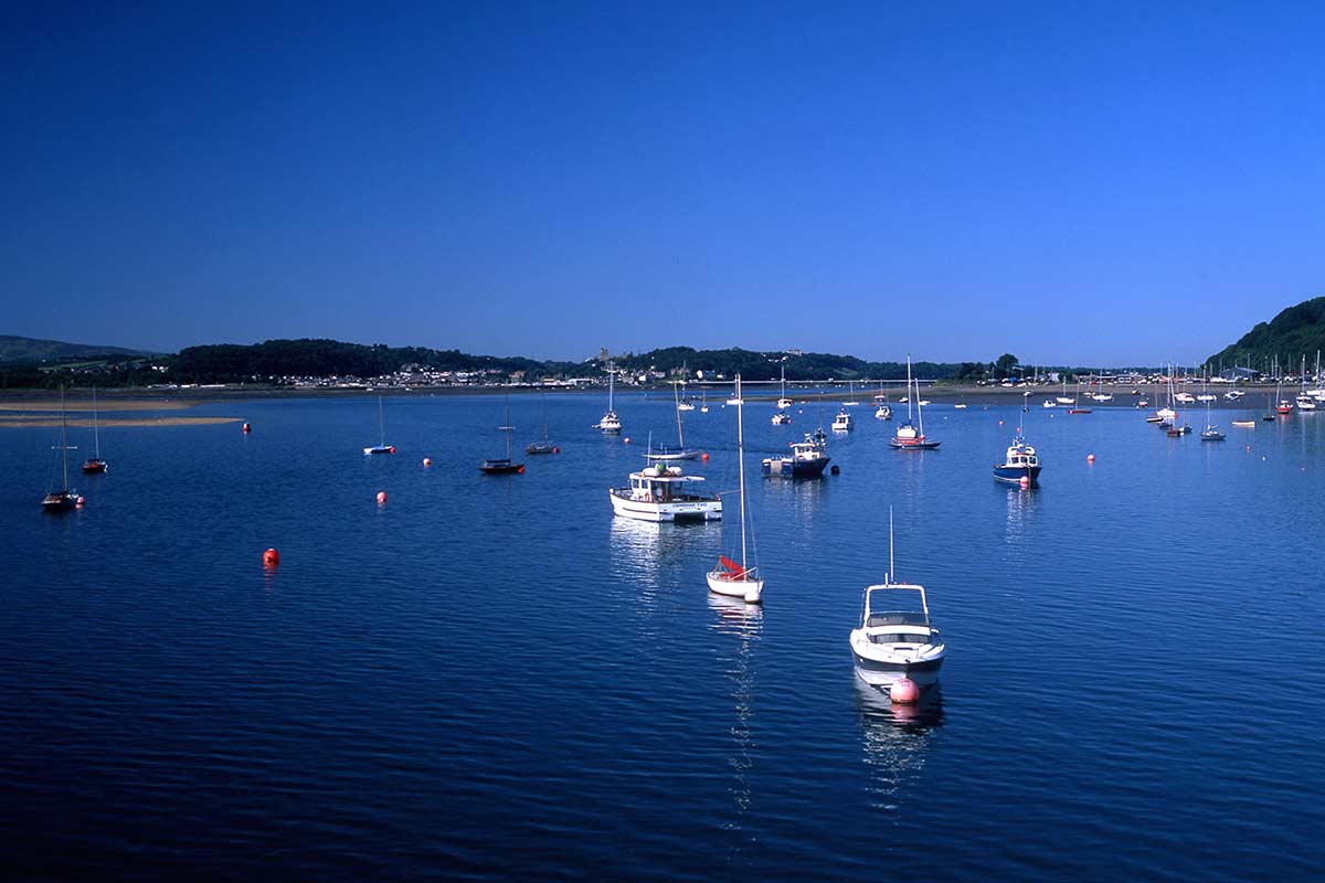 image of boats on Menai strait from Beaumaris pier anglesey north Wales uk
