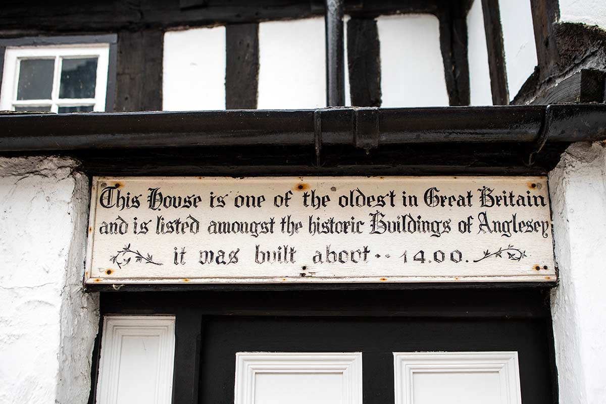 image of sign on medieval house in Beaumaris anglesey north Wales uk