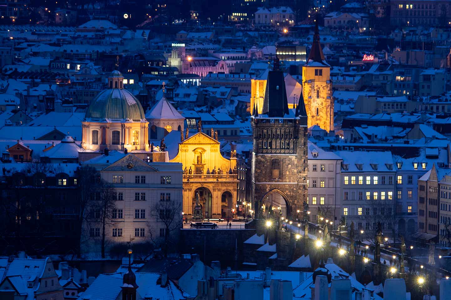 Czech Republic in winter image of Old Town Prague in snow at dusk