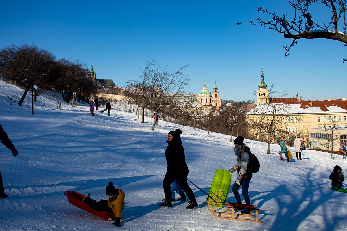 image of people pulling sleds up petri hill prague czech republic