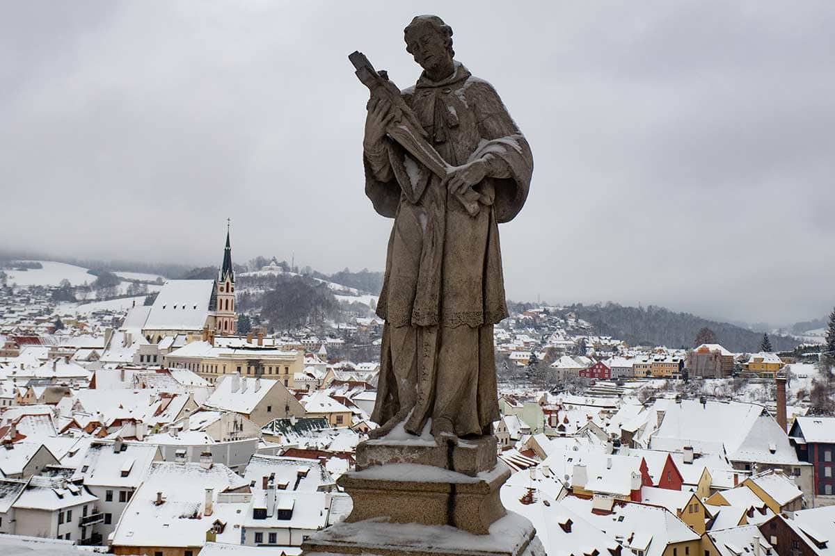 image of statue on cloak bridge overlooking cesky krumlov