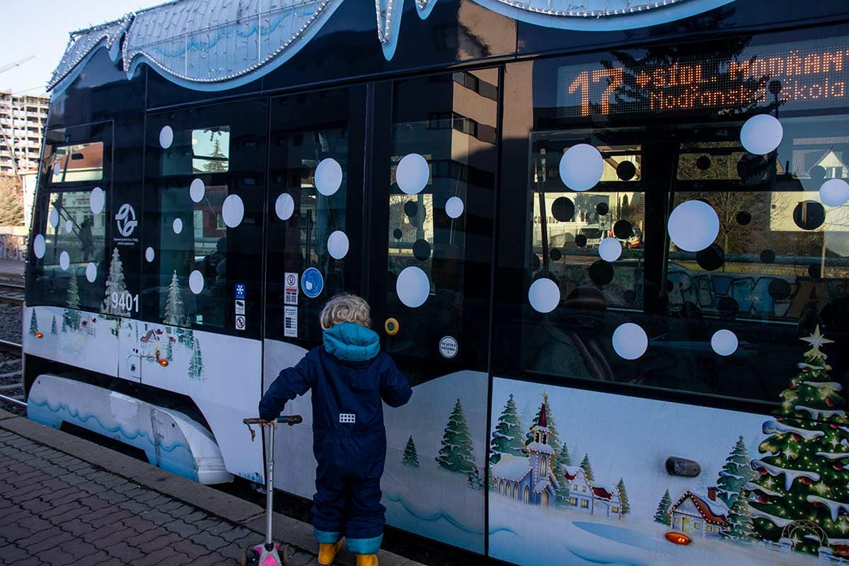 image of boy boarding prague Christmas tram