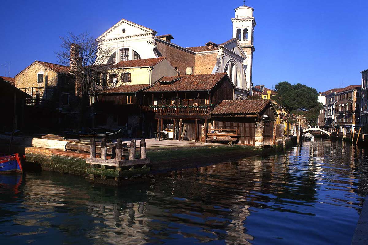 image of rio di san trovaso canal, church and boatyard venice italy