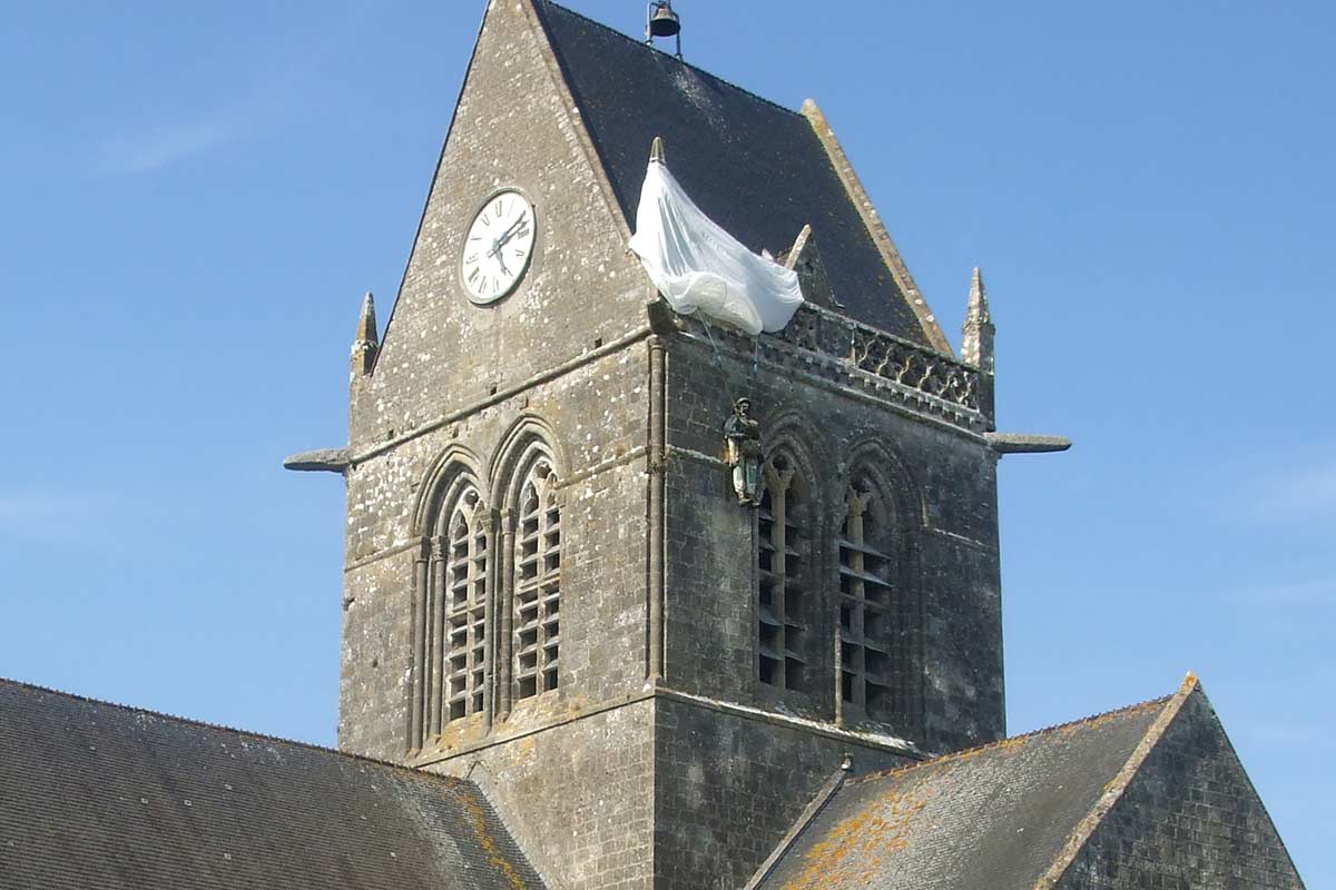 image of parachutist model on church tower ste mere Eglise normandy france