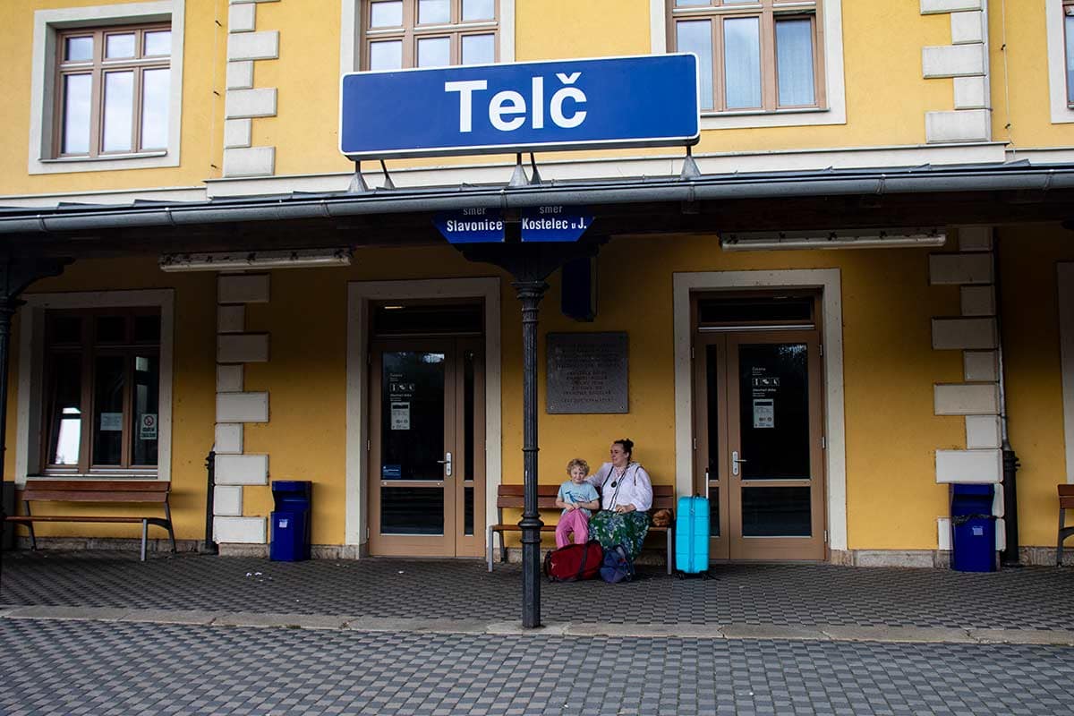 I'm age of woman and son outside Telč train station czech republic