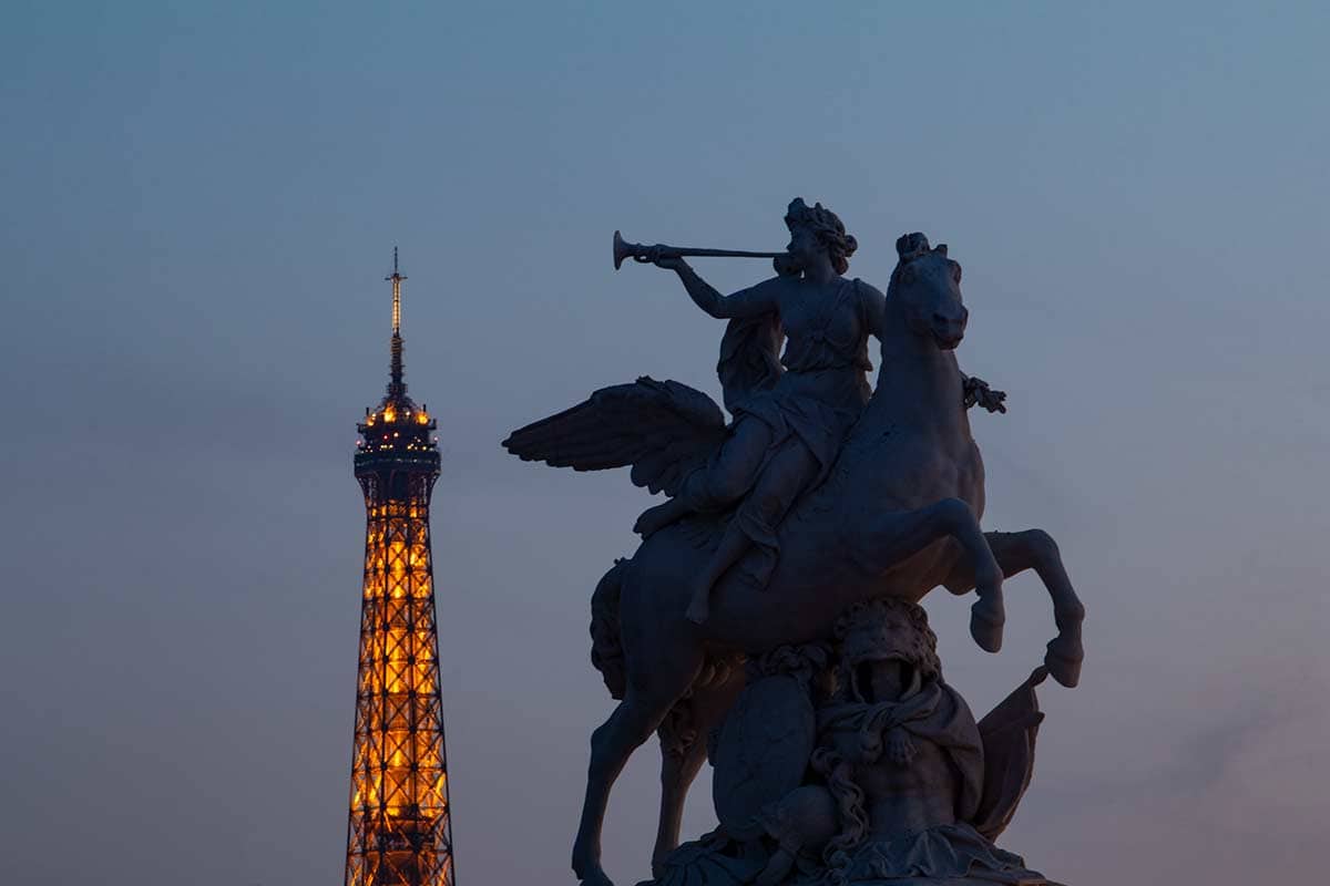 image of statue and Eiffel Tower summit at dusk place de la Concorde Paris france