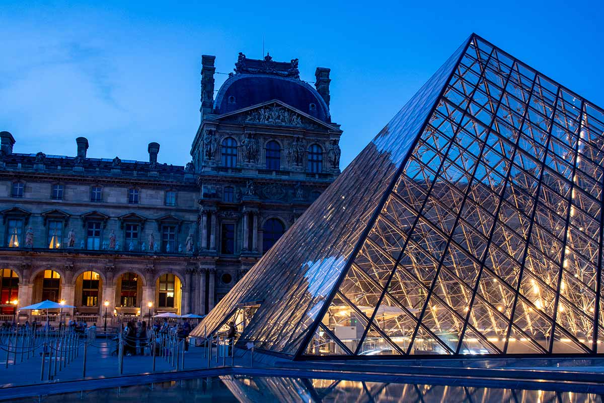 image of Louvre pyramid at dusk Paris france