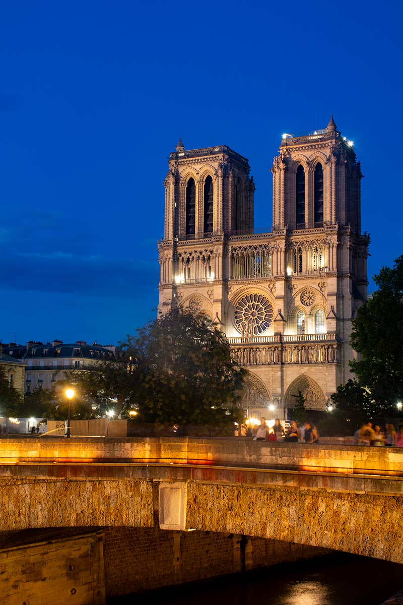 image of west front of Notre dame cathedral Paris at dusk