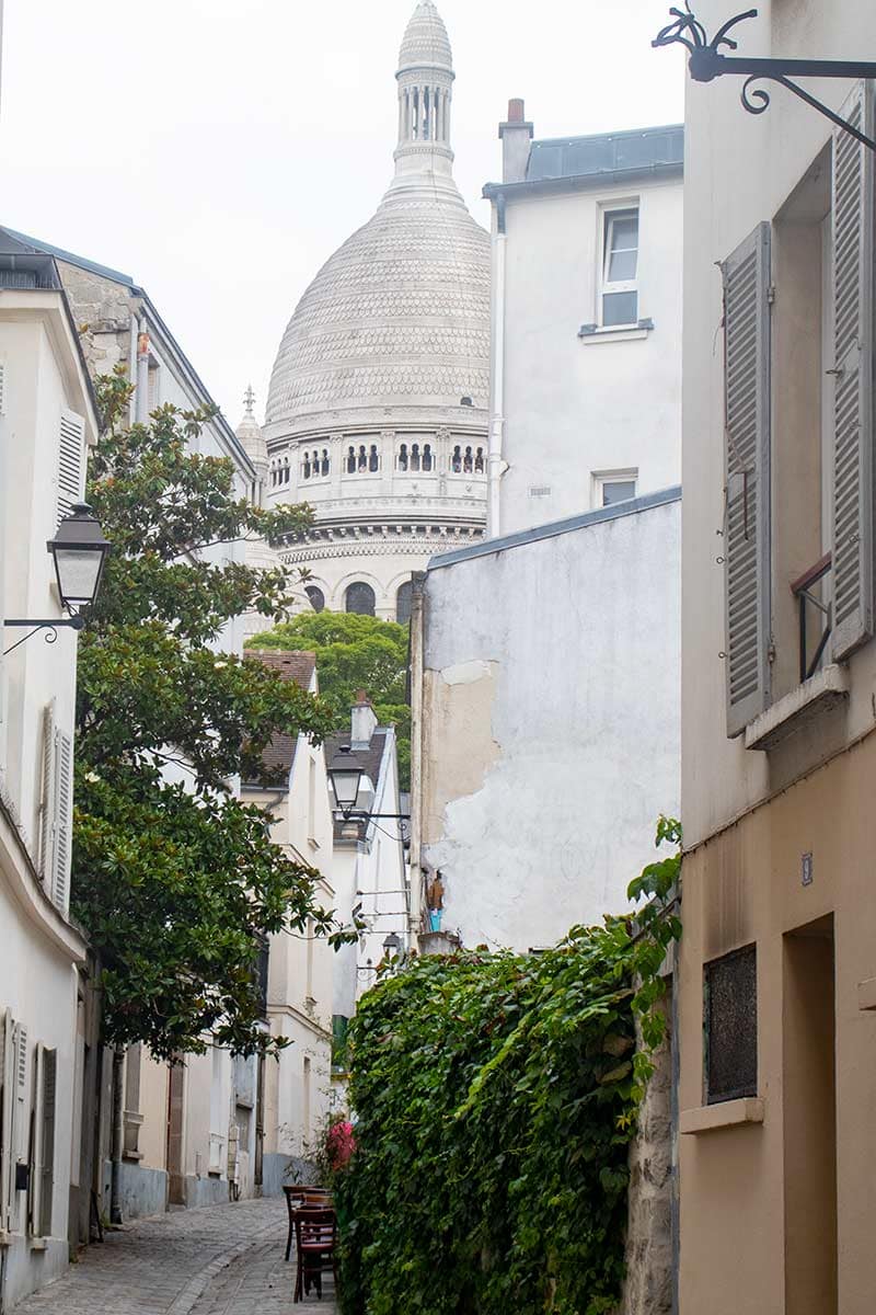 image of sacre coeur basilica along rue saint rustique Montmartre Paris france