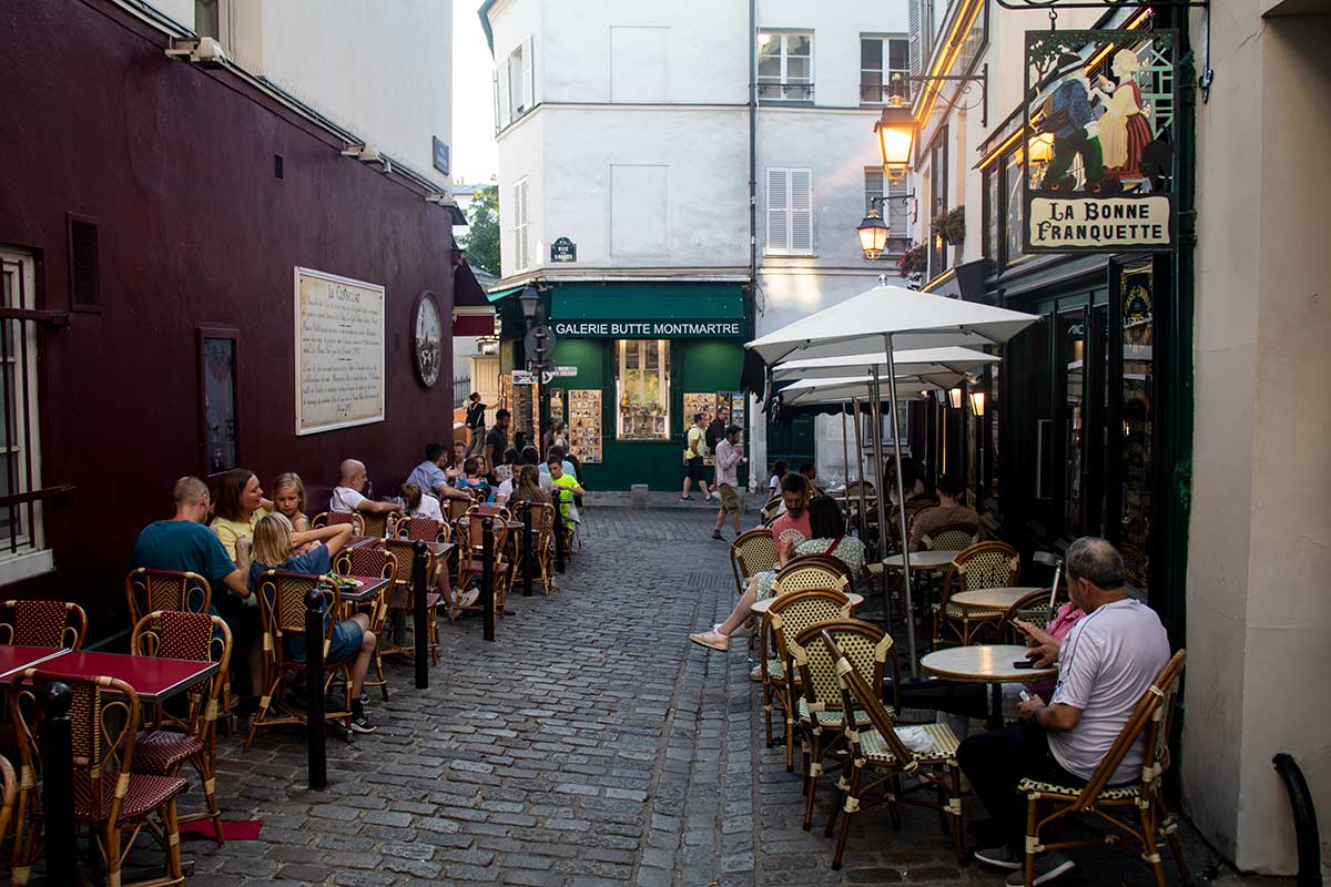 image of people at tables outside la Bonne franquette and le consult restaurants Montmartre Paris france