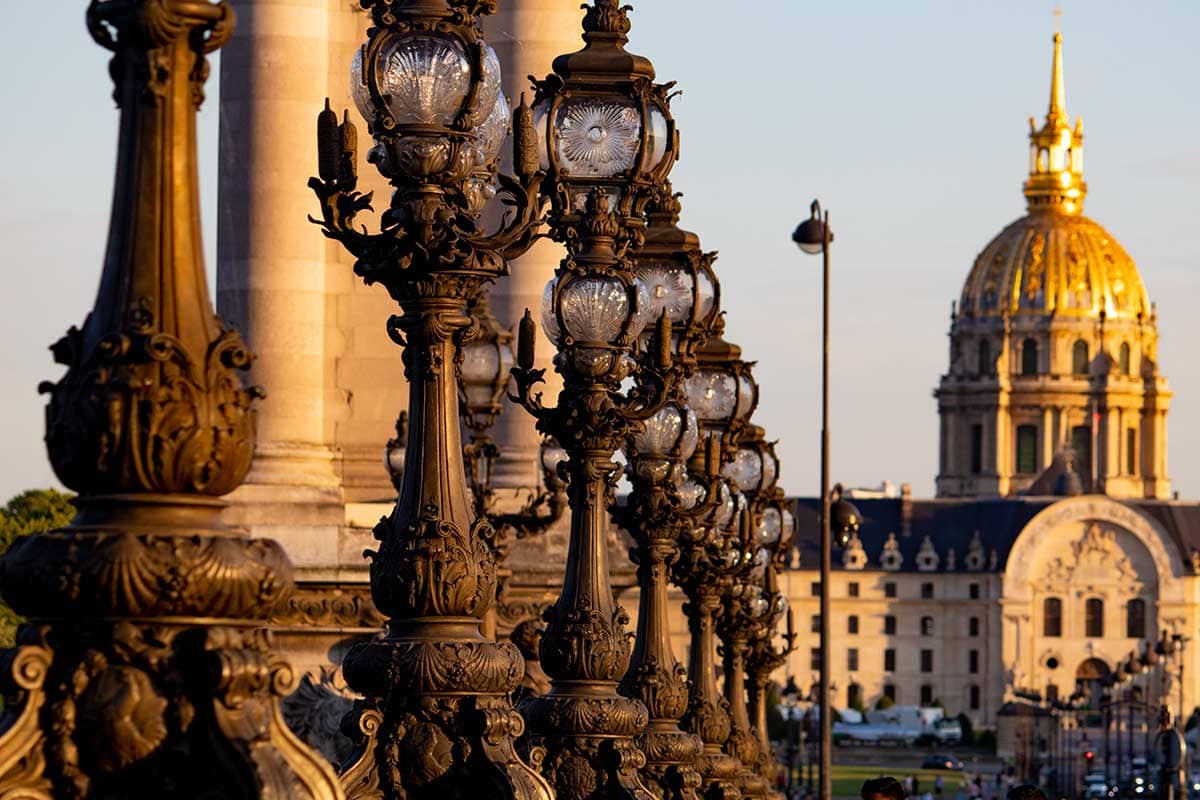 image of art nouveau lamp posts and invalides dome pont Alexandre iii paris france