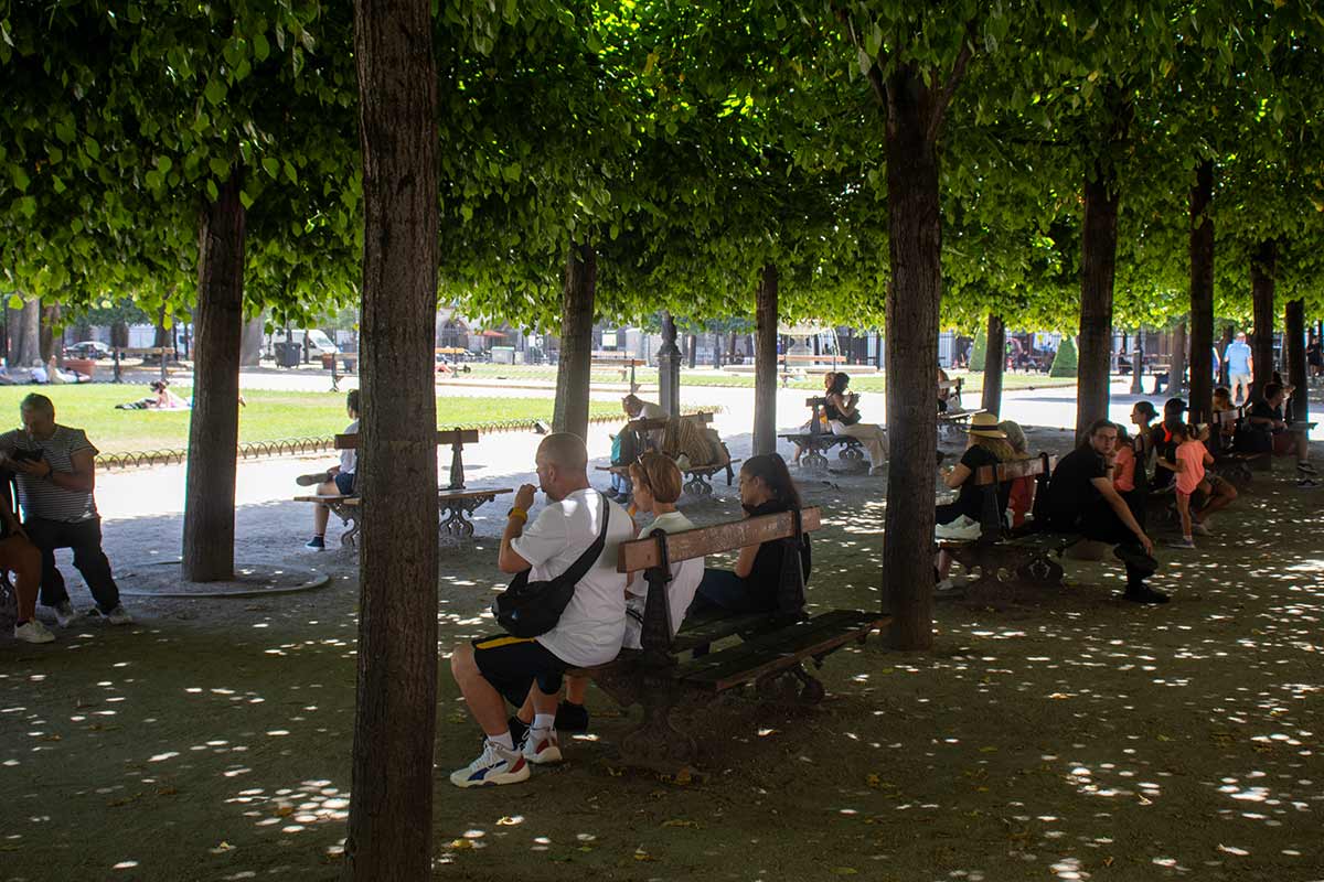 image of people sitting in the shade in the place des vosges gardens Paris france