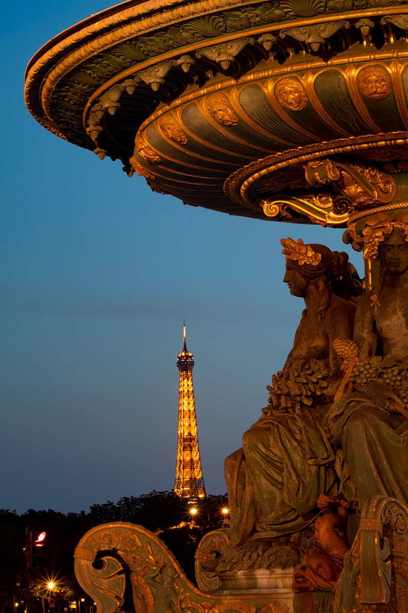 image of figure in fontaine des mers and Eiffel Tower at dusk place de la Concorde Paris france