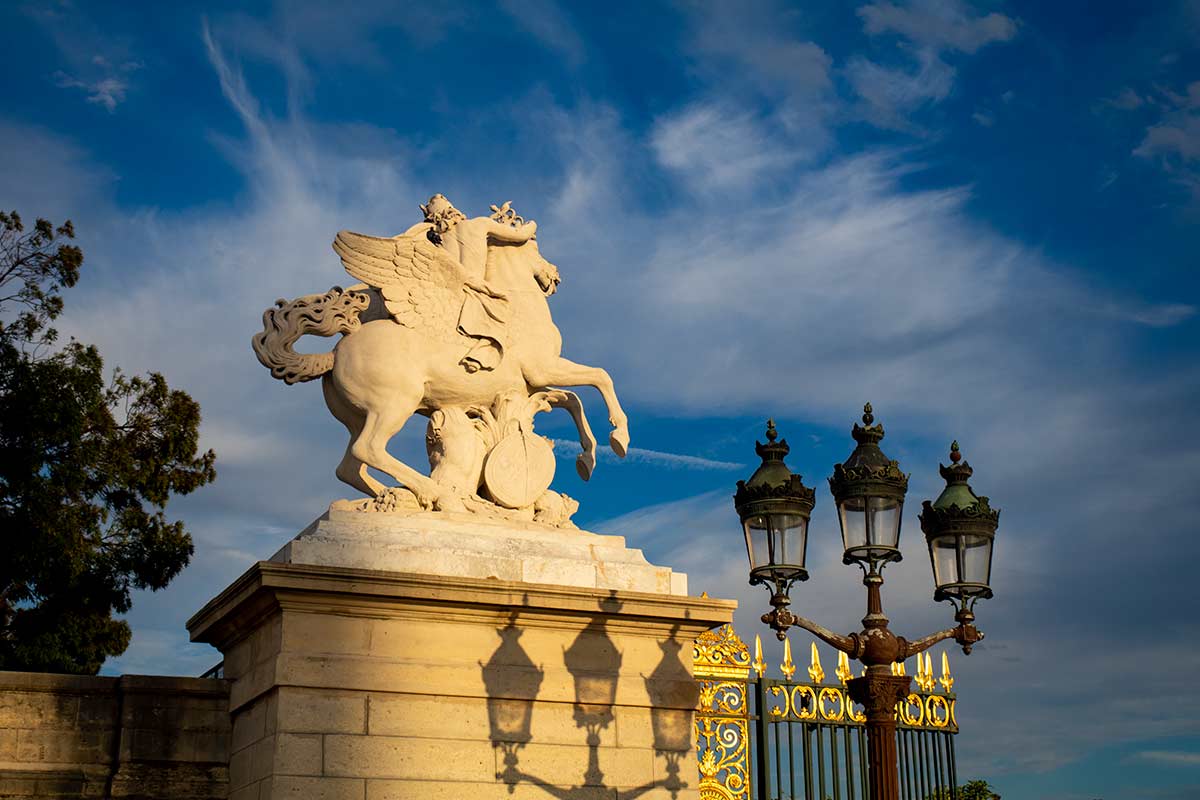 image of mercury riding pegasus statue next to west gate of Tuileries garden Paris france
