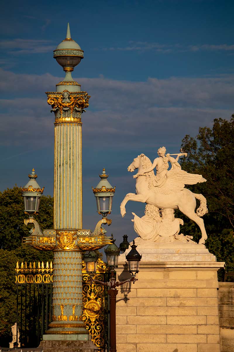 image of ornate lamps and statue of fame riding pegasus place de la Concorde Paris france