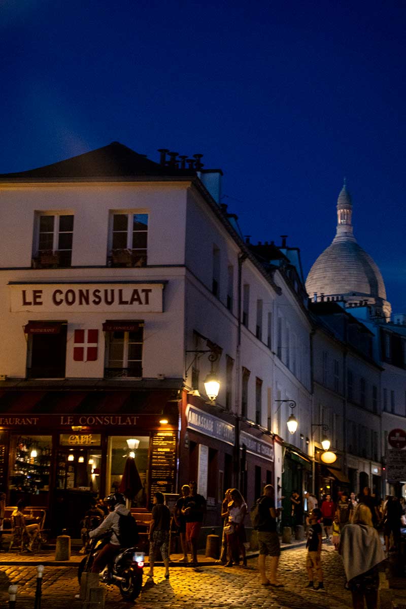 image of le consulat restaurant and sacre coeur basilica Montmartre Paris france