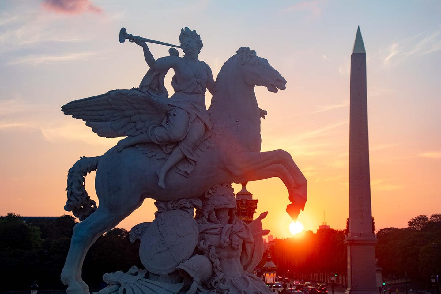 visiting place de la Concorde Paris image of statues and obelisk at sunset Paris france